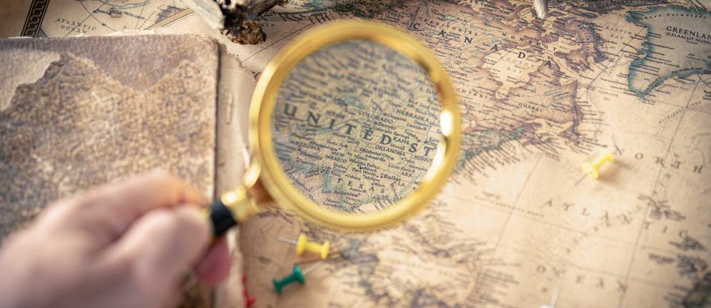 Magnifying glass over a world map