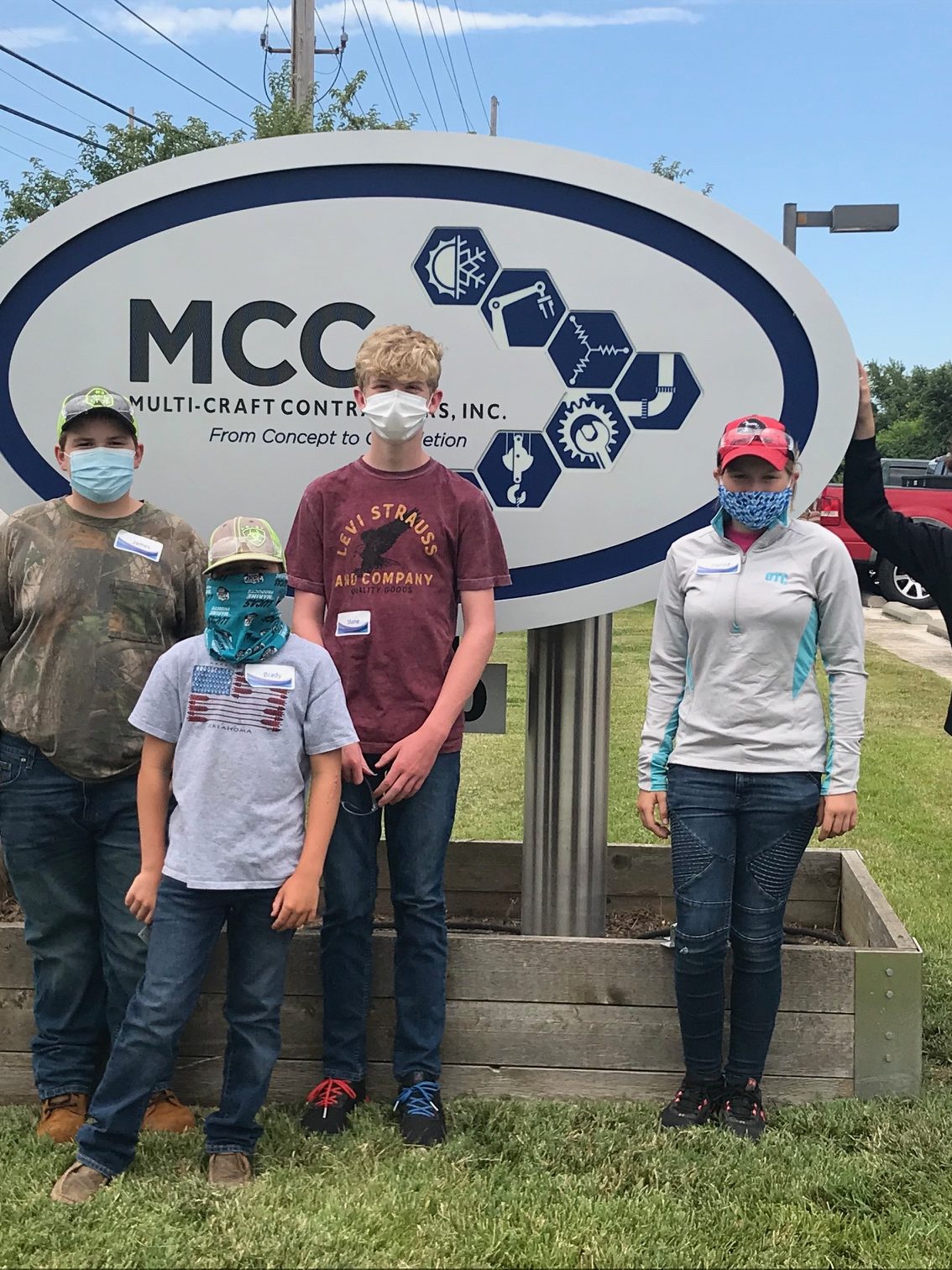 Students posing in front of MCC sign
